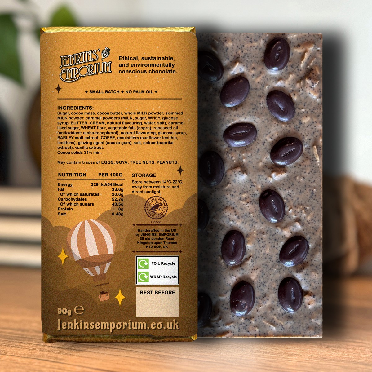 The back of a blonde chocolate bar studded with dark chocolate coffee beans
